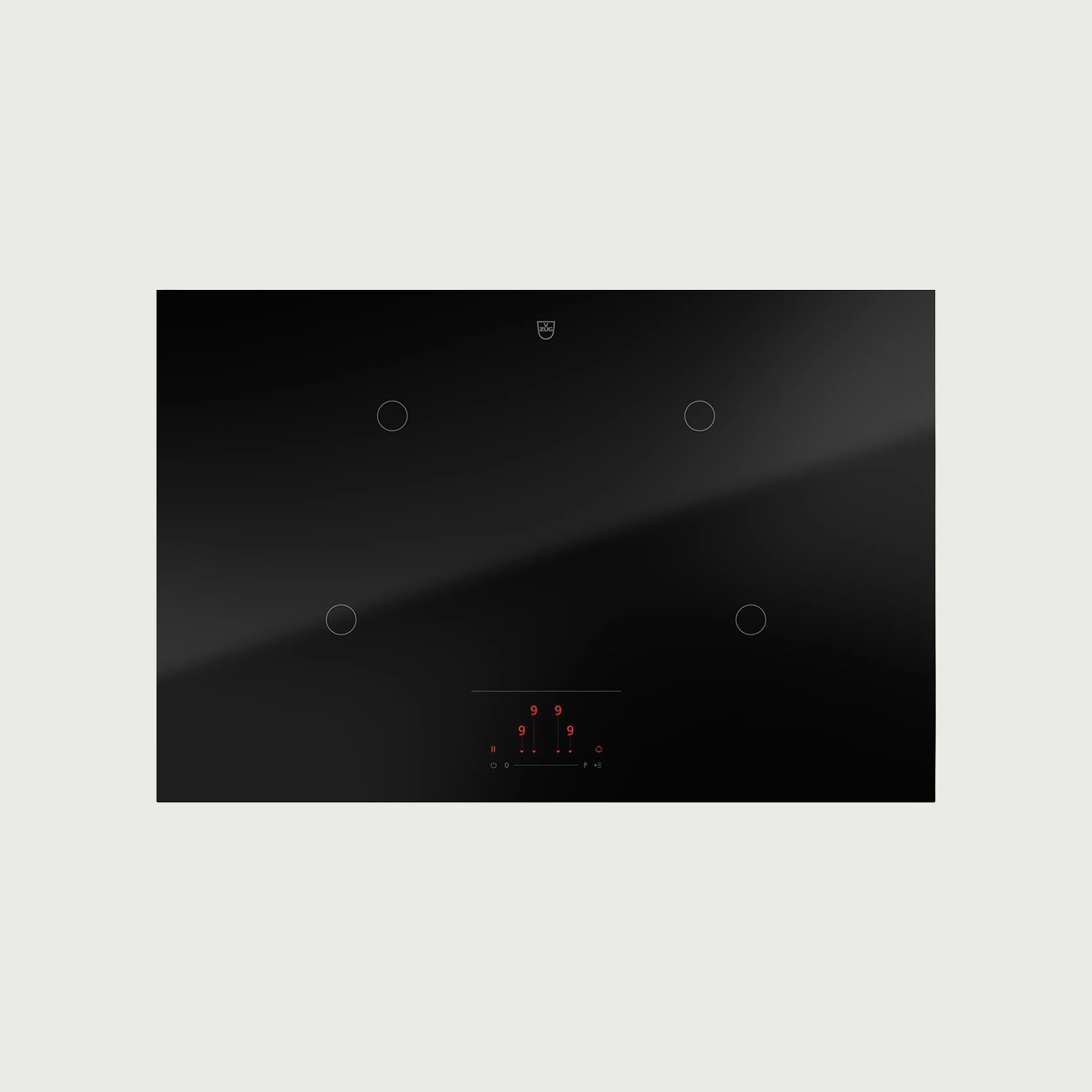 Eine moderne, schwarze Induktionskochplatte mit vier Kochzonen und einem digitalen Bedienfeld.